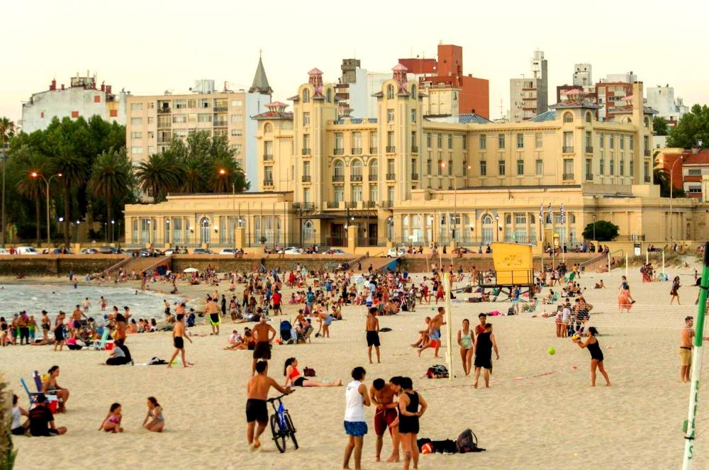 Sonnenuntergang am Strand von Ramyres mit Badenden an einem Sommertag in Montevideo Uruguay